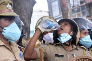 A Kerala cop quenching her thirst while on duty in front of the Secretariat (Photo | Vincent Pulickal, EPS)